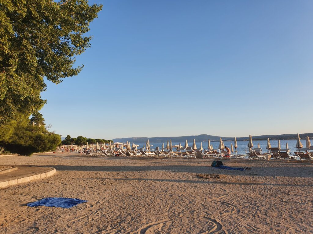 Rzędy parasoli na piaszczystej plaży w Crikvenicy o poranku